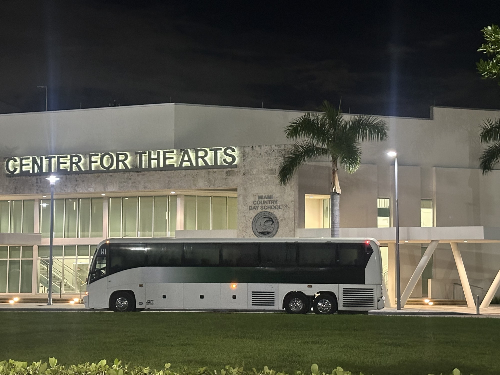 JGT motorcoach outside a venue at night