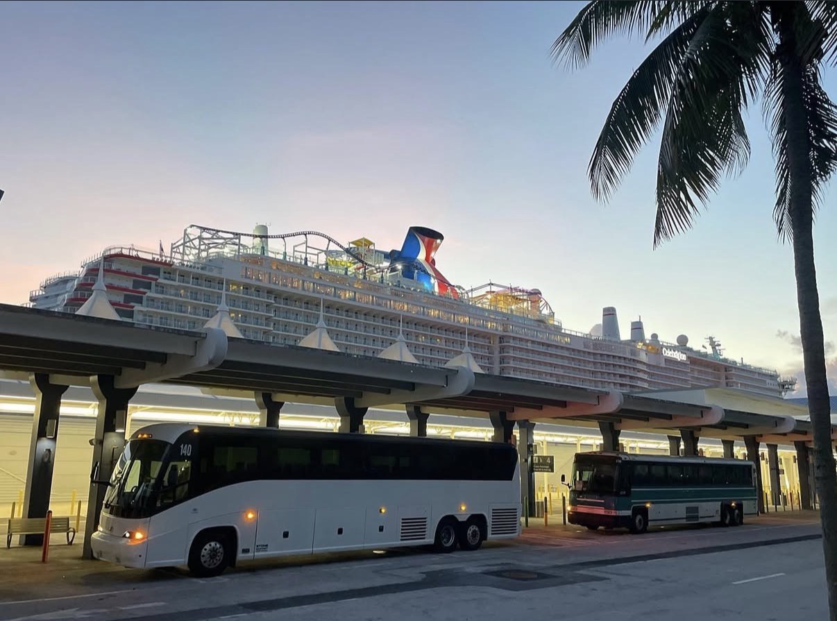 JGT motorcoach beside a cruise terminal